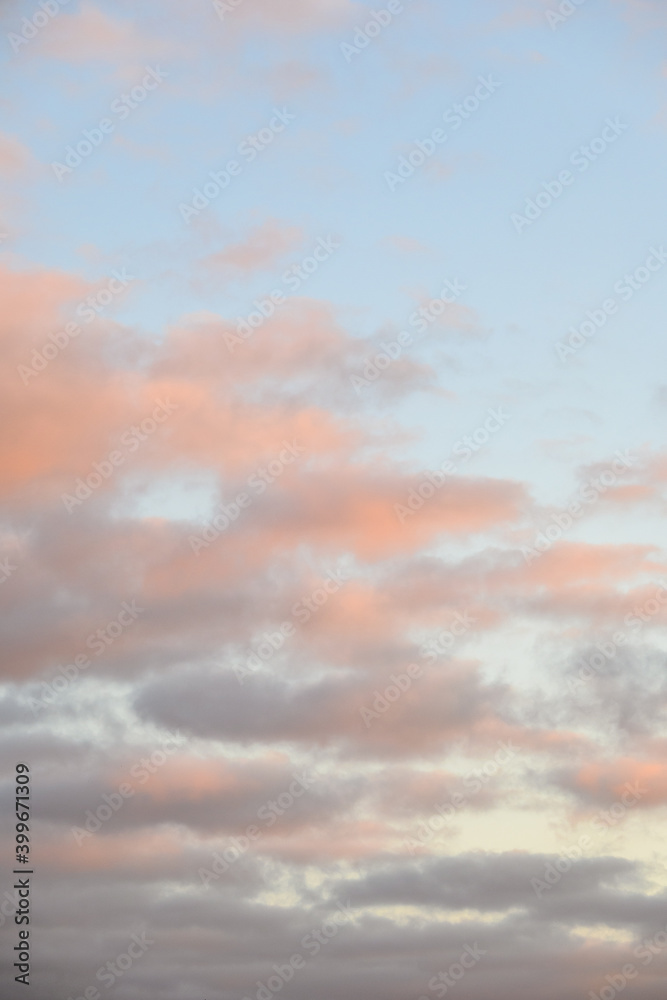 Fototapeta premium Peaceful pastel light in an evening sky, blue sky and fluffy clouds as a nature background 