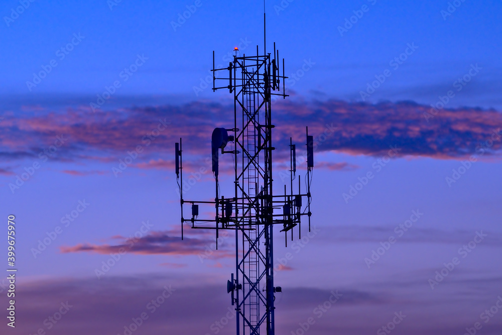 telecommunications tower over cold sunset sky