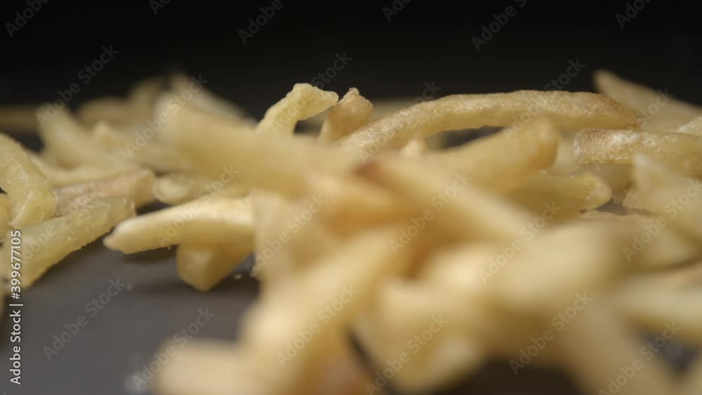 French fries with salt close up slow motion studio, tasty fast food French fries with salt close up slow motion studio, tasty fast food