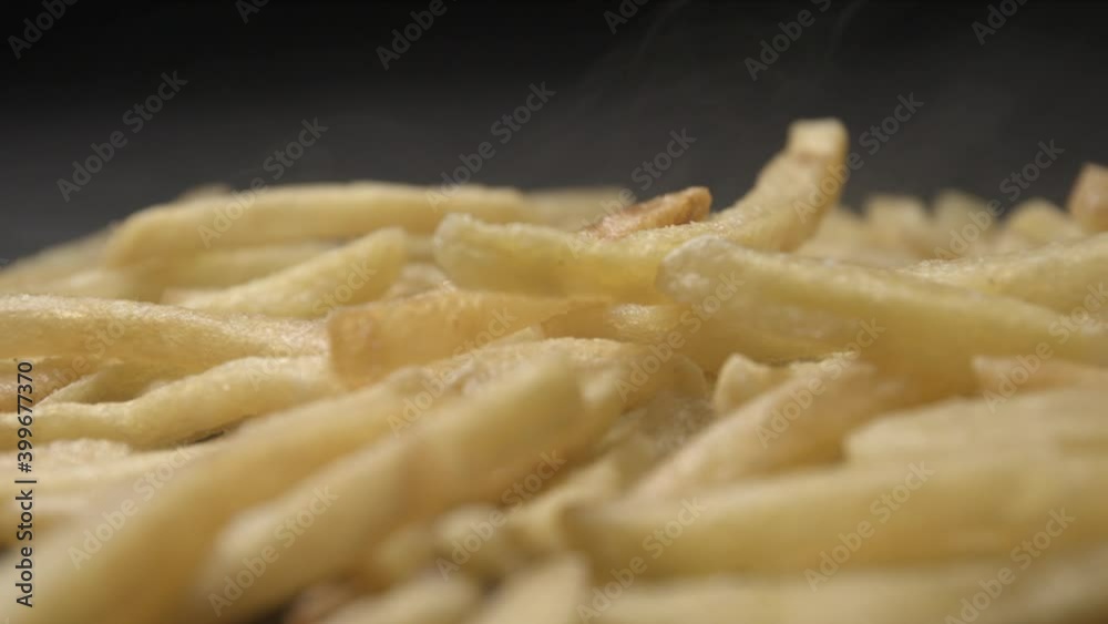 French fries with salt close up slow motion studio, tasty fast food French fries with salt close up slow motion studio, tasty fast food