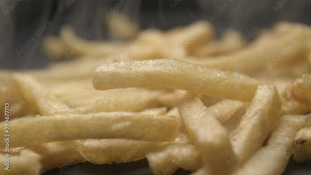 French fries with salt close up slow motion studio, tasty fast food