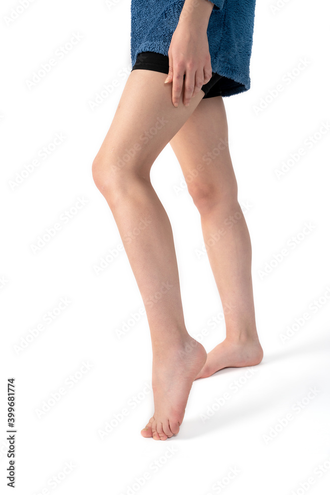 Close-up of naked woman's legs isolated on white background