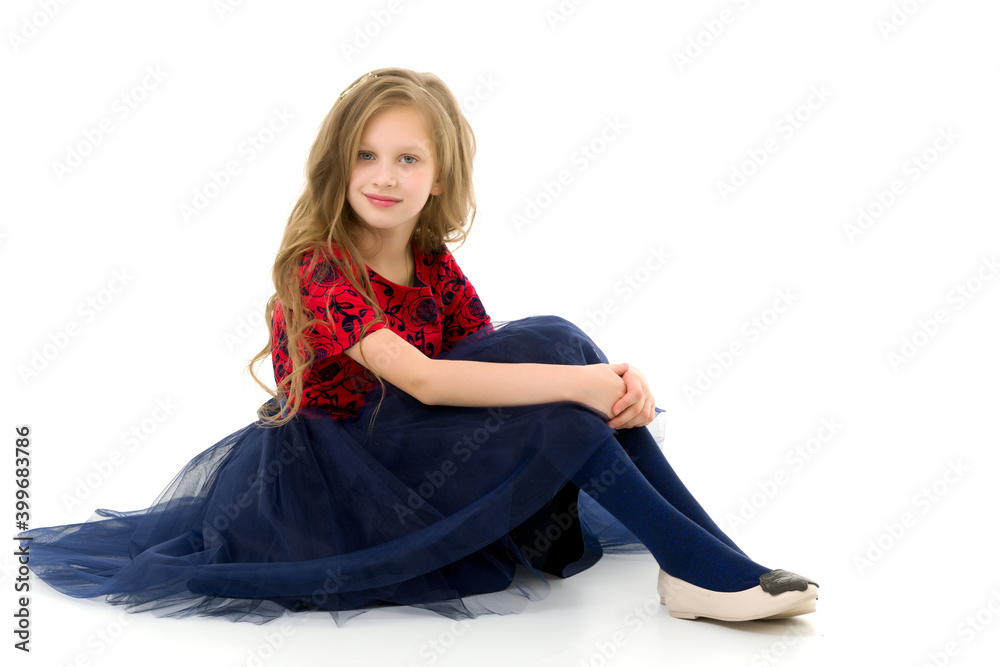 Naklejka premium Blonde Girl in Stylish Tulle Dress Sitting on Floor Hugging her Knees
