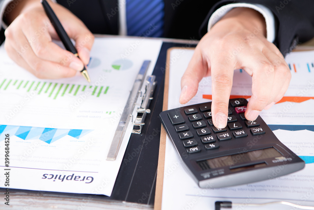 Accountant using a calculator for accounting Accountant using a calculator for accounting