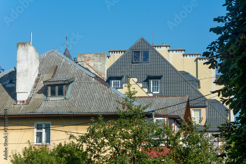 Skylights on roof of multi-storey building. Attics and chimneys in architecture. Selective focus, blur
