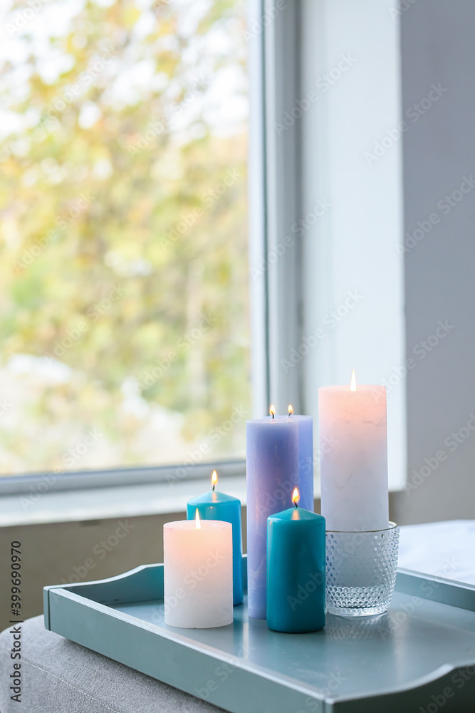 Tray with burning candles in interior of bedroom Tray with burning candles in interior of bedroom