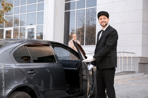 Chauffeur opening door of l...