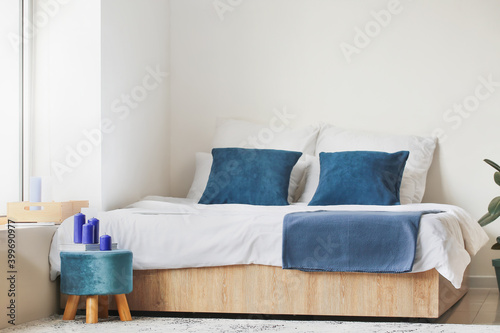 Pouf with candles in interior of bedroom