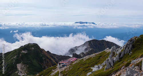 Grassy Kiso Mountains and Mount Ontake along the horizon in early autumn at Senjojiki Cirque in Nagano Prefecture, Japan. photo