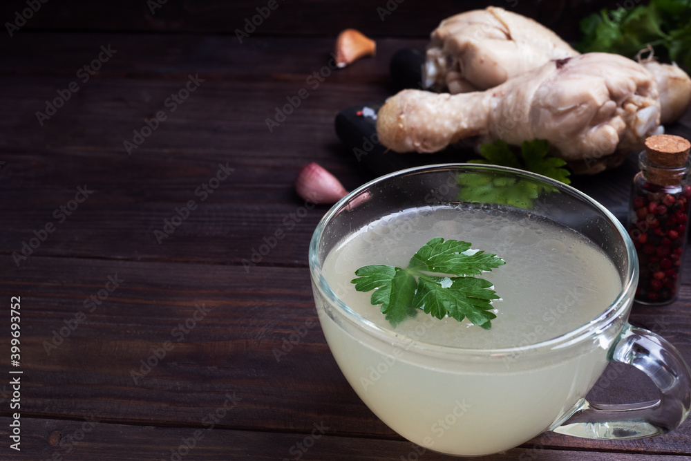 Chicken broth in a glass Cup. Boiled chicken leg quarters. Healthy food with collagen and amino acids. Chicken broth in a glass Cup. Boiled chicken leg quarters. Healthy food with collagen and amino acids.