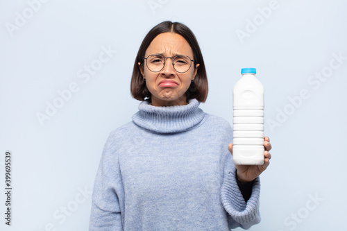 young latin woman feeling sad and whiney with an unhappy look, crying with a negative and frustrated attitude photo