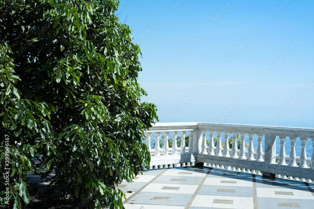 Exterior building with natural tree foreground and white marble modern fences background with clear blue sky top view at Doi Inthanon, Chiang Mai popular tourism landmark in the North of Thailand