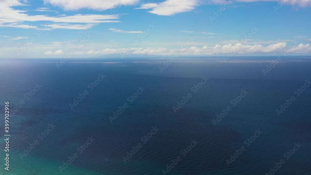 Seascape, aerial view. Flight over the sea. Blue sea and sky with clouds. Summer and travel vacation concept. Seascape, aerial view. Flight over the sea. Blue sea and sky with clouds. Summer and travel vacation concept.