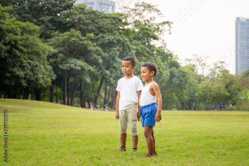 Portrait of two happy kids boys funny playing outdoors in a park, Kids playing concept.