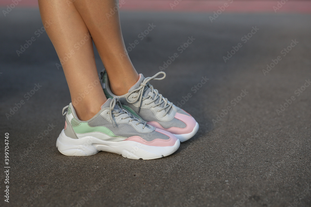 woman legs in sneakers close up