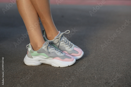 woman legs in sneakers close up