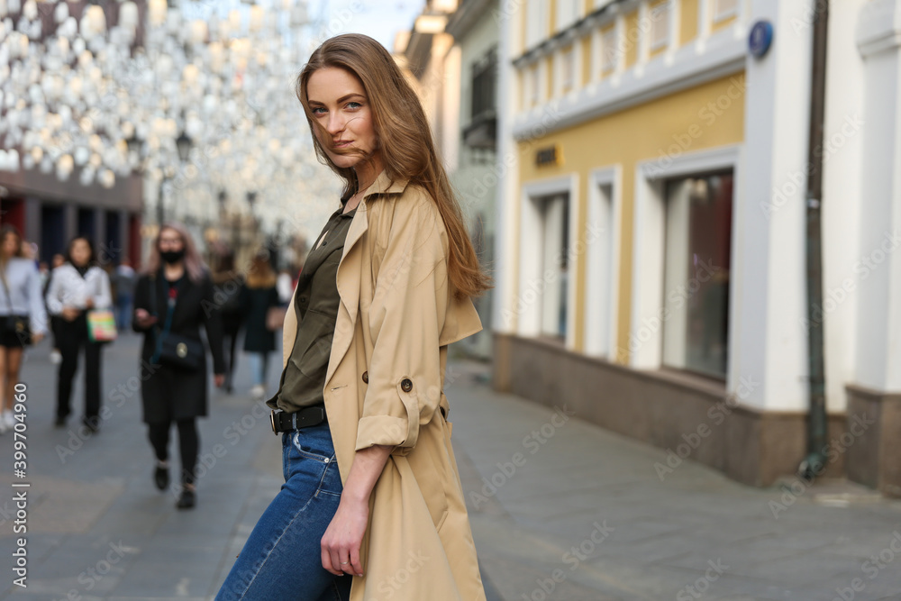 a girl of European appearance walks in the city center in spring a girl of European appearance walks in the city center in spring