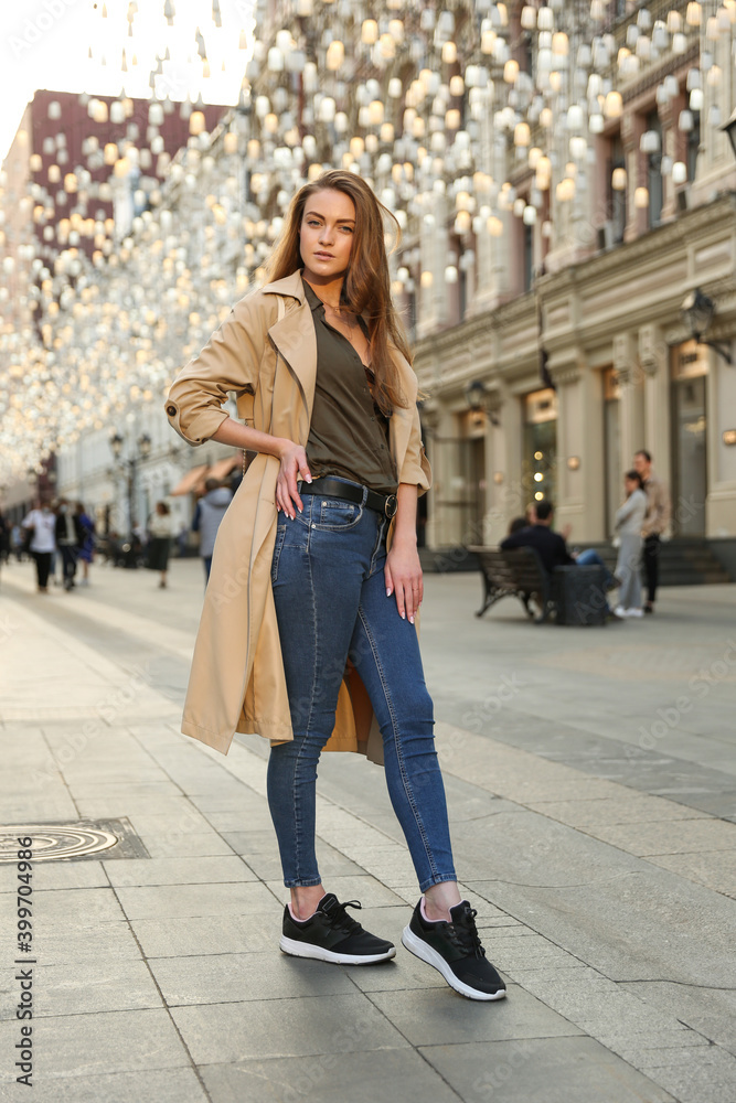 a girl of European appearance walks in the city center in spring