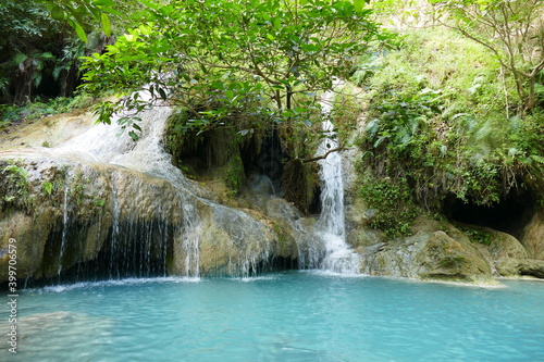 Photo picture of a fascinating view Thailand waterfall and the azure water with colors on the sun