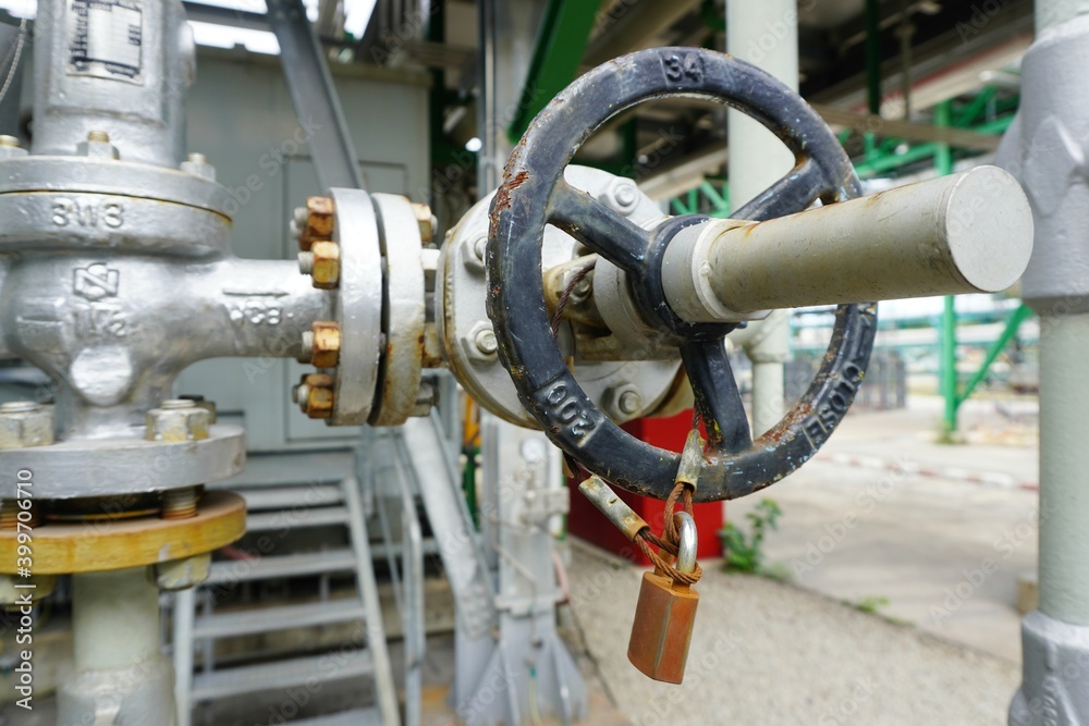 Key lock and chain to prevent the valve being opened is part of the Lock out tag out system in oil and gas plant. Key lock and chain to prevent the valve being opened is part of the Lock out tag out system in oil and gas plant.
