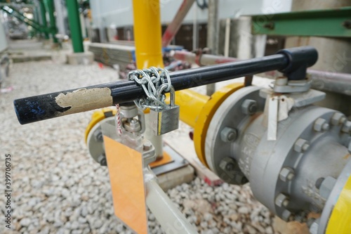 Key lock and chain to prevent the valve being opened is part of the Lock out tag out system in oil and gas plant.