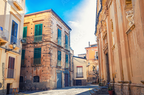 Typical italian narrow street of Tropea town historical centre with old buildings and Church of Jesus of the Convent of the Fathers Redemptorists, Vibo Valentia, Calabria, Southern Italy