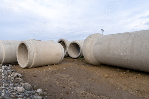 concrete sewage pipes on the ground prepare for underground instalation