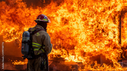 a fireman stands in front of flames