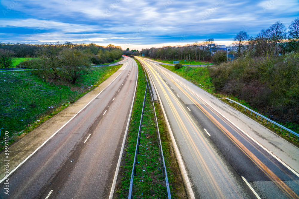 Long exposure view of A1M motorwayy with cars light trails at sunset