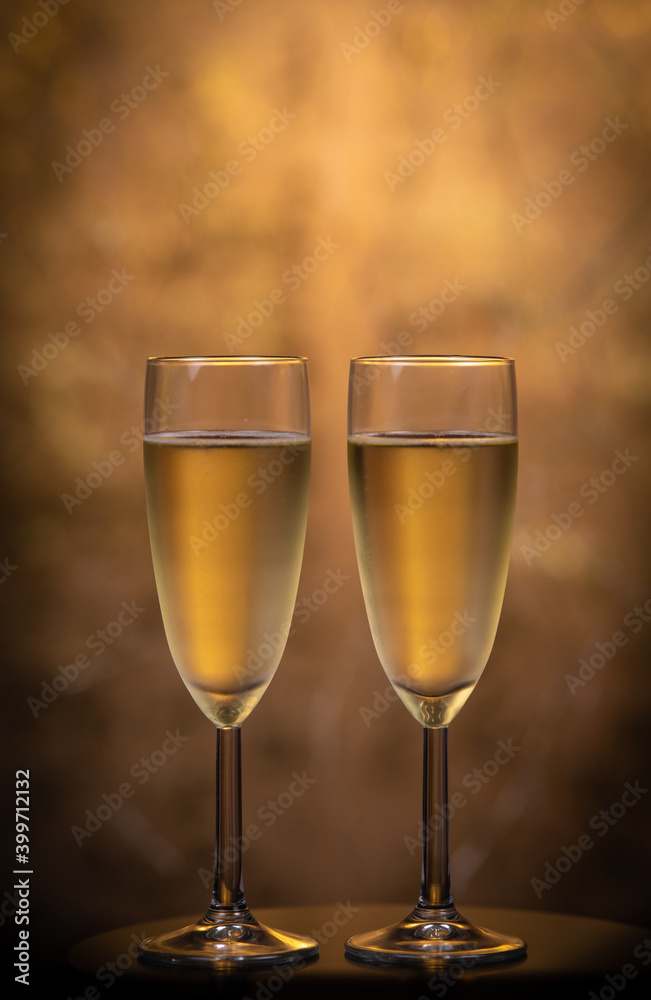 Champagne glasses over holiday bokeh blinking background, rotating on turntable, glasses with sparkling wine, celebration, party. High quality 4k footage
