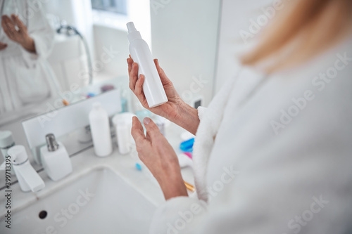 Image of beautiful female arms with body lotion in room indoors