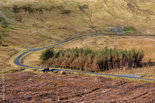 Scene at The Gleniff Horseshoe loop drive in county Sligo, Ireland, Old school house, small road. Travel and tourism concept photo