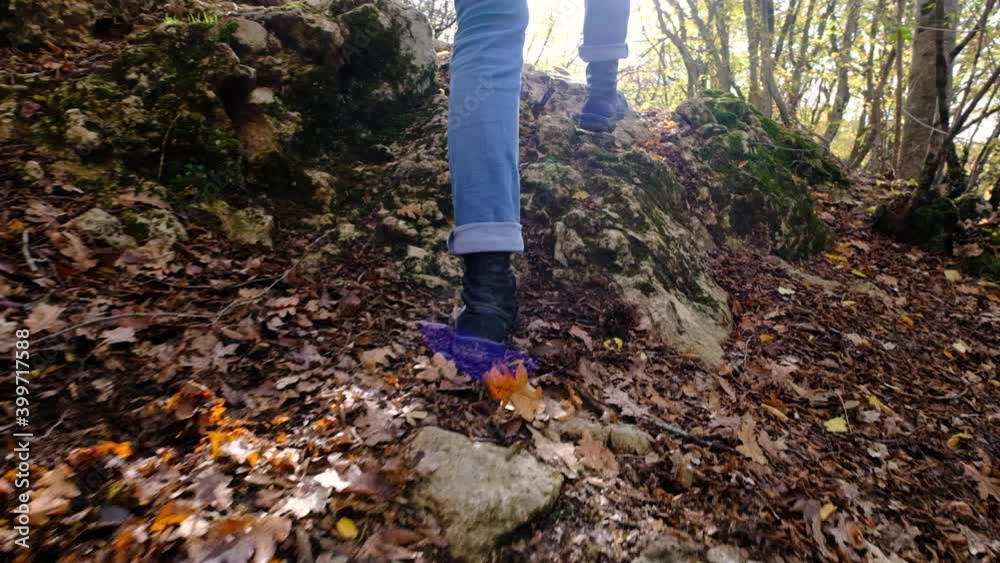 Close up follow shot of female boots walk in middle of small mountain trail in forest. Close up follow shot of female boots walk in middle of small mountain trail in forest.