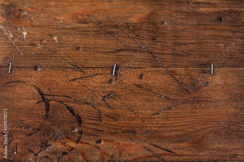 Background of brown old boards with scratches and metal staples, horizontal view