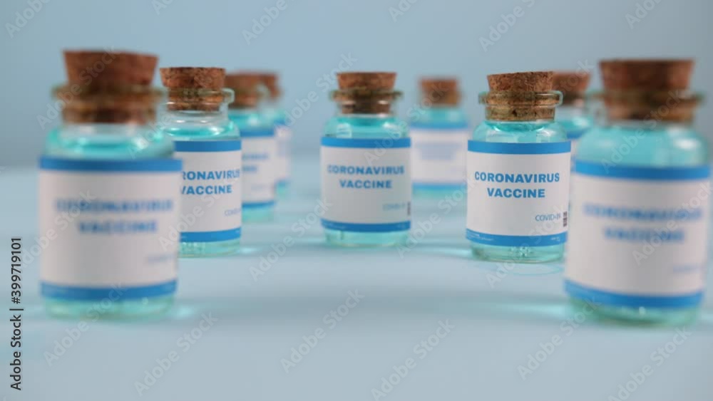 Syringe needle, a drop liquid, blurred pfizer company on the blue background. Coronavirus vaccine concept. Covid-19 inoculation jointly developed. Ready-made preparations with doses Syringe needle, a drop liquid, blurred pfizer company on the blue background. Coronavirus vaccine concept. Covid-19 inoculation jointly developed. Ready-made preparations with doses
