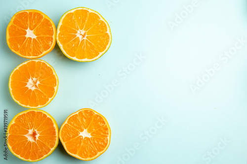 top view fresh tangerine slices on light-blue background color fruit orange photo citrus grapefruits free space