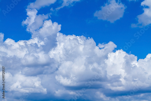 White clouds on a blue sky. Blue sky with heavy clouds. Clouds floating on the sky.