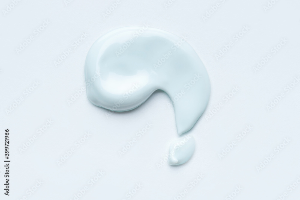 Light blue smear of cosmetic clay or cream on a white background. Light blue smear of cosmetic clay or cream on a white background.
