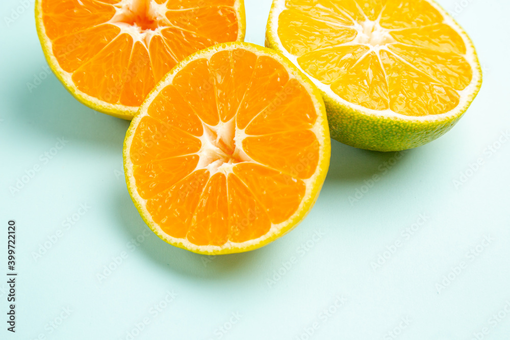 Fototapeta premium front view fresh tangerine slices on the light-blue background fruit orange photo color citrus grapefruit