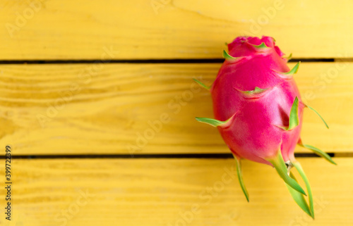 Dragon Fruit on yellow wooden background, copy space.