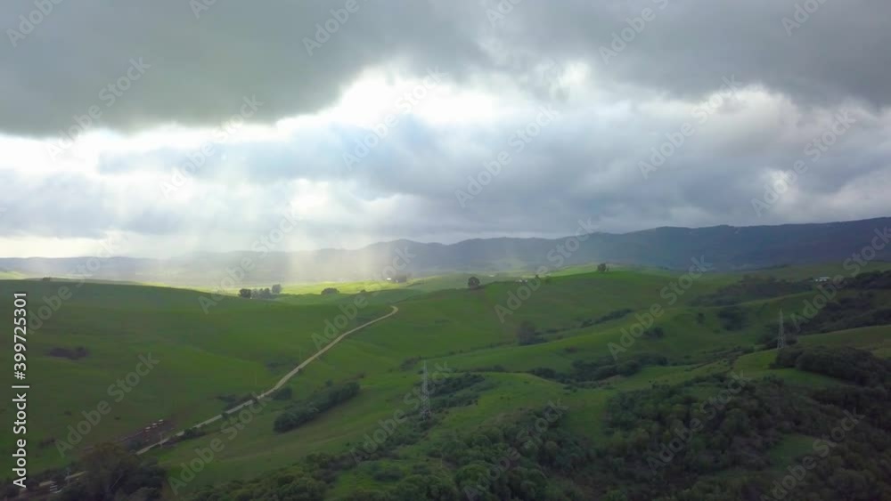 different aerial shots of a green meadow illuminated by sunlight filtered through the clouds different aerial shots of a green meadow illuminated by sunlight filtered through the clouds