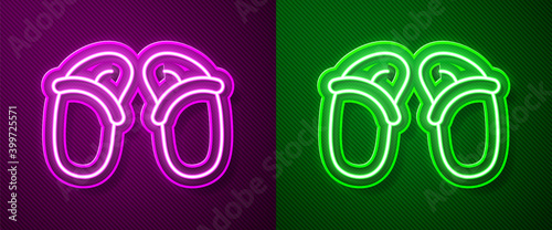Glowing neon line Flip flops icon isolated on purple and green background. Beach slippers sign. Vector.