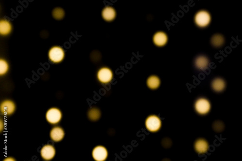 background with bokeh, christmas lights on a black background, shiny defocus sparkle for a celebration, no person