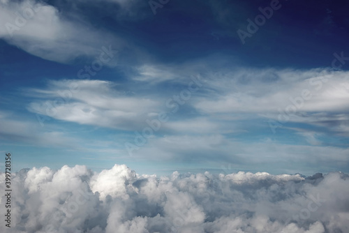 Fototapeta Naklejka Na Ścianę i Meble -  The photo was taken while flying on a plane, beautiful blue sky and white plump clouds