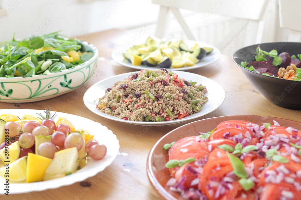 Fresh salad with garnishing and meal on table