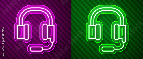 Glowing neon line Headphones with microphone icon isolated on purple and green background. Vector.