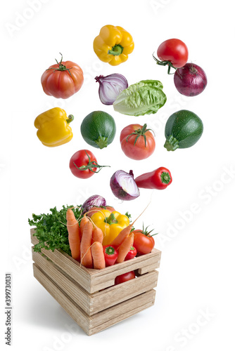 Slika na platnu Fresh vegetables flying in a wooden box isolated from white background