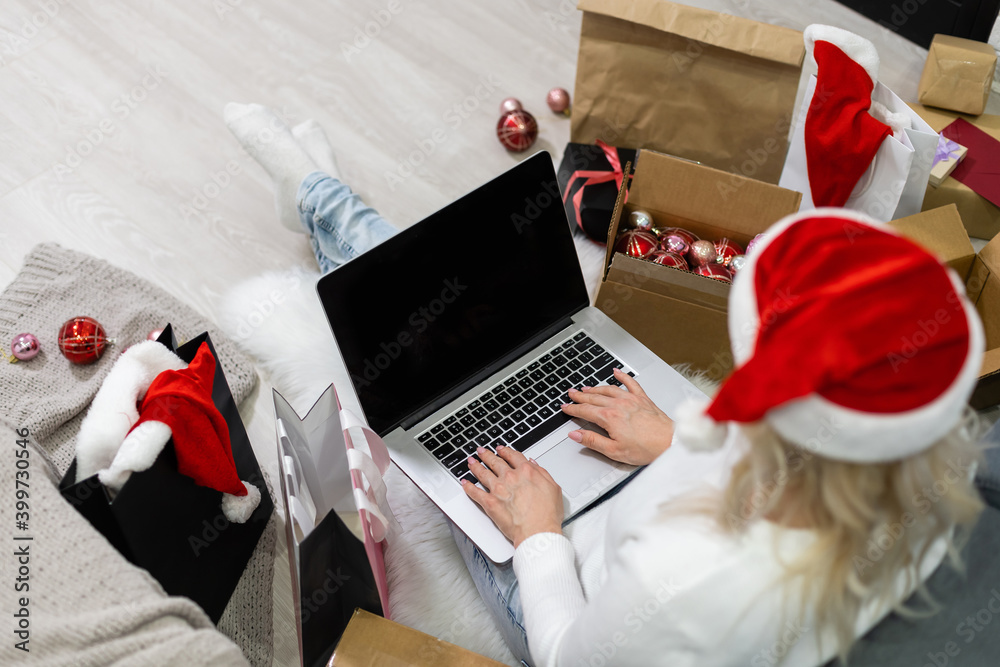 Young woman ordering Christmas gifts online Young woman ordering Christmas gifts online