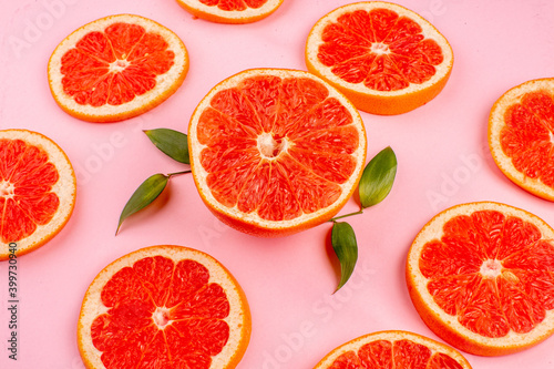 front view tasty grapefruits sliced juicy fruits lined on pink background healthy life juice fresh color diet