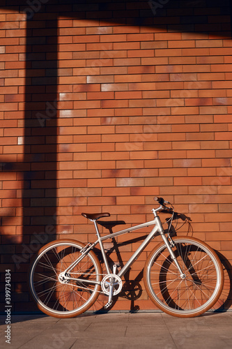 Bicycle parked near brick wall